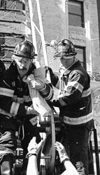FF Matt Barnes brings precious cargo down the aerial ladder to waiting arms of EMS personnel.