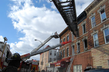 Units operate at the fire on Central Avenue where three children and their grandmother were rescued through a third floor window. Photo courtesy of Joseph Epstein, FDNY Dispatcher