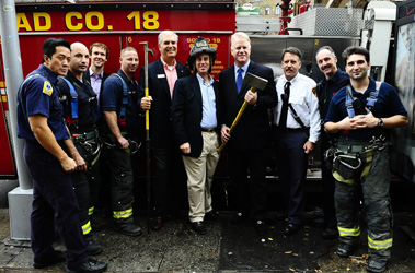 Bank of America presents $40,000 check to the FDNY Foundation. (L to R) NFL analyst Boomer Esiason, Bank of America Banking Center Manager Edwin Warren, Assistant Chief James Esposito, Captain Brian Smith of Squad 18, Bank of America Northeast Region Executive Jeff Barker and FDNY Fire Safety mascot Hot Dog.