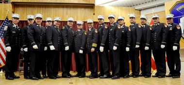 Chief of Department Salvatore Cassano stands with the newly promoted members at the Fire Academy.