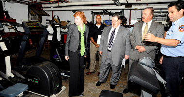 Capt. Steven Gentiluomo of Ladder 78 shows Steve Parnes (second from right) and Helen Cetta from Kornreich-NIA, and Terry McCormick (third from right) from Fireman's Fund Insurance Company some of the equipment the company has already purchased using the grant.