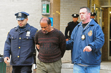 Fire marshal John Watkins (right) helps escort alleged arsonist Christopher Buxo