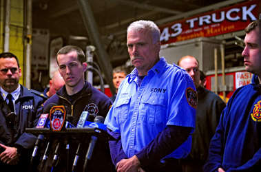 Lt. Gregory Prial (center) describes the East Harlem fire where he, Firefighter John Haseney (second from left) and Firefighter John Hemsley (far right) helped rescue an unconscious woman.