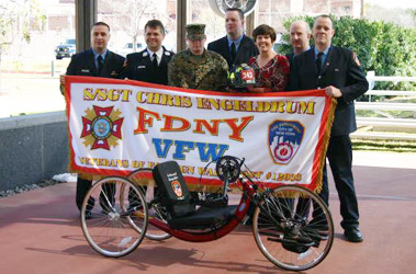 Members of the FDNY VFW Post, Capt. Paul Conrad of Division 6, Firefighter Patrick McElvaney of Ladder 22, Firefighter Billy Hayes of Ladder 45, Firefighter Justin Devine of Ladder 45 and Firefighter Mike Cook of Ladder 27, donated a hand-crank bike to wounded veteran Matt Bradford (in camouflage utilities) in Texas.