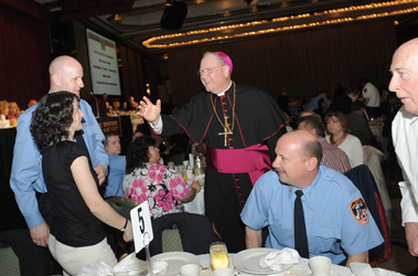 New York Archbishop Timothy Dolan presided over the mass at St. Patrick's Cathedral before greeting guests at the breakfast nearby at the New York Hilton.