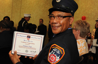 EMT George Trail shows off the certificate he received recognizing his 20 years of service.