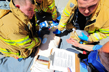 EMTs treat a simulated victim who went in to cardiac arrest during the 2009 EMS Competition.