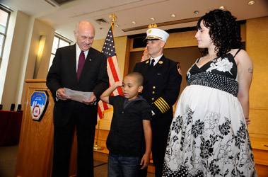 Fire Commissioner Nicholas Scoppetta and Chief of Department Salvatore Cassano swear in 5-year-old Tahlique Garay as a junior paramedic as he stands beside his mom, Jennifer Garay, at FDNY Headquarters on Aug. 12.