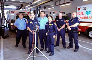 Capt. John Scotch (third from left), EMTs Andrew Gabor (second from left) and EMT Claudia Rugel address the media at EMS Station 32.