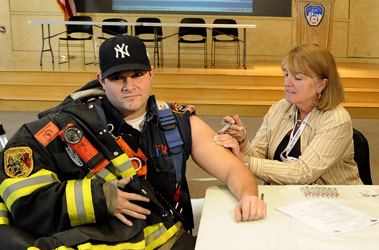 A firefighter receives the H1N1 vaccine during BIOPOD 2009.
