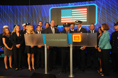 FDNY firefighters join NYPD police officers and representatives from Tuesday's Children and the National 9/11 Memorial Museum to ring the NASDAQ opening bell.