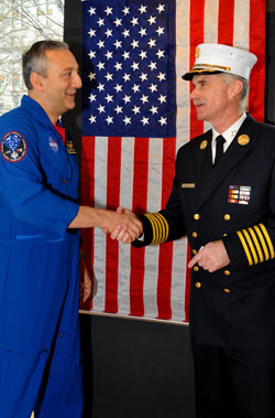 Chief of Department Edward Kilduff and Astronaut Mike Massimino in front of the flag that was flown in space in honor of all those who died on Sept. 11, 2001.