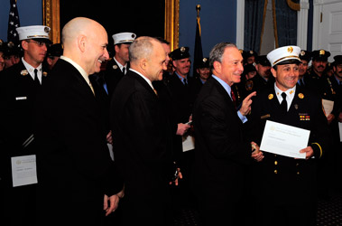 Chief Joe Downey, whose father started the Urban Search and Rescue team before his death at the World Trade Center, receives a certificate of appreciation from Mayor Michael Bloomberg, Fire Commissioner Salvatore Cassano and Police Commissioner Ray Kelly.