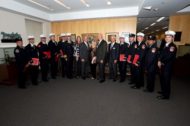 The scholarship recipients with Fire Commissioner Salvatore Cassano, Chief of Department Edward Kilduff, Salvatore Bommarito and the Brick family.