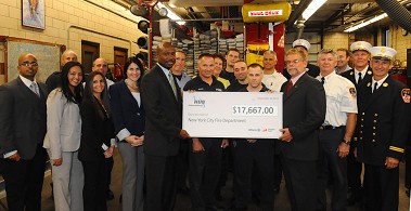 Representatives from Fireman's Fund Insurance and HUB International Northeast join members of Engine 324 and Division 14 on their apparatus floor.