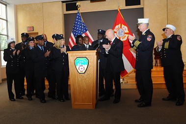 (L to R) Lt. Melissa Ovalle, Paramedic Dukens Jean Baptiste, Paramedic Justine Abruzzo, EMT Jerard Washington, EMT Michael Coleman, EMT Paul Larow, EMT Crystal Guzman, Donna Gilkes, Drew Champagnie, EMT Dwayne Gilkes, Fire Commissioner Salvatore Cassano, Chief of Department Edward Kilduff and Chief of EMS Abdo Nahmod.