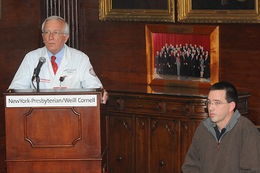 Dr. Roger Yurt (standing), Director of the Burn Center, and Douglas Wiedmann, Firefighter Robert Wiedmann's brother.