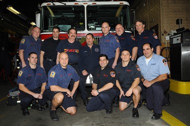 Firefighter Thomas Wollack (seated, center), with members of Engine 247.
