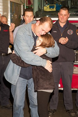 Survivor John Stalzer with his daughter, Brianna, visits Engine 221 to thank the FDNY members who saved his life.
