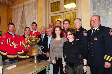 FDNY senior staff and members of the FDNY Hockey Team with representatives from RAF in front of the trophy awarded to the FDNY team for their win over the EMERCOM Russian firefighters.