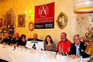 Fire Commissioner Salvatore Cassano holds up his Russian hockey jersey presented to him by RAF. (L to R) Chief of Operations Robert Sweeney, Chief of Fire Prevention Thomas Jensen, President of RAF Marina Kovalyov, Commissioner Cassano, Vice President of RAF Rina Kirshner, FDNY Hockey Team Manager Mike Rossidis and FDNY Hockey Team General Manager Bill Kammerer.