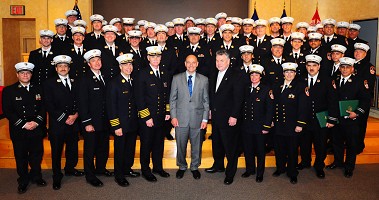 The sixty-four graduates with Fire Commissioner Cassano and Congressman Peter King