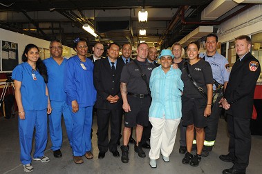 Rosa Thomas with the EMS members, firefighters and medical professionals from Lincoln Hospital who saved her after she went into cardiac arrest in March.