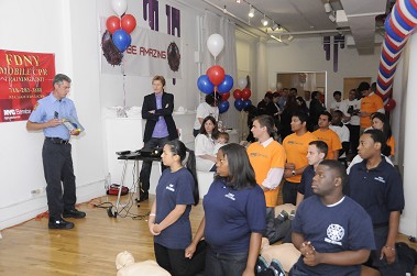 Volunteers learn CPR from representatives from the FDNY's CPR Training Unit at the Leary Firefighters Foundation offices as actor Denis Leary looks on.