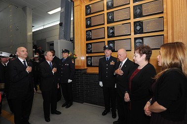 Mayor Michael Bloomberg; Fire Commissioner Salvatore Cassano; the DiBernardo family, including his father, Deputy Chief Joseph DiBernardo, Sr., mother, Barbara, and sister, Carolyn; and ceremonial officers pause for Taps as a plaque on Rescue 3's memorial wall is dedicated for Lt. Joseph DiBernardo.