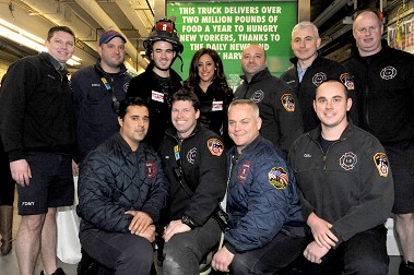 The members of Engine 8 and Ladder 2 with Kevin and Danielle Jonas.