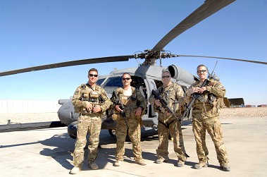 (L to R) FFs Shaun Cullen, Tripp Zanetis, James Denniston and Erick Pound in front of their HH-60 Pave Hawk helicopter. The men served together as part of the 101st Rescue Squadron in Afghanistan. Photo courtesy of Air Force Master Sgt. James Martin.