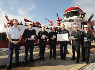 Members of FDNY's Marine Operations, including Marine 9, with representatives from the U.S. Coast Guard who presented the U.S. Coast Guard Meritorious Public Serivce Award.