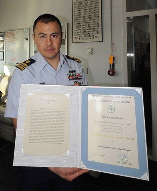 Commander James McLay with the Award presented to the members of Marine 9.