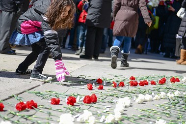 Flowers were laid at the location as the names of the victims were read.
