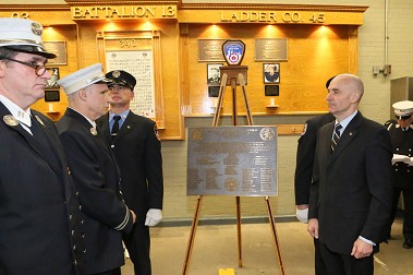 A plaque is unveiled, which marks the 100 year anniversary of the firehouse.