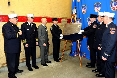 A plaque is unveiled to honor the firehouse's 100 years.