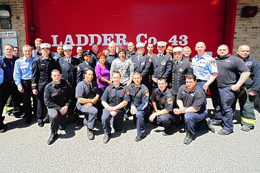 Joseph Barone, with his wife Cadida (center) and the many FDNY members who rescued him.
