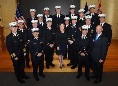 Fire Commissioner Salvatore Cassano, Chief of Department Edward Kilduff and FOMI Faculty Director Joann Baney with the 2012-2013 program graduates.