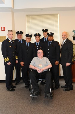 Cooper Anderson, who was sworn in as an honorary FDNY firefighter, with Fire Commissioner Salvatore Cassano, Chief of Department Edward Kilduff and the members of Ladder 115.