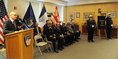 Fire Commissioner Salvatore Cassano speaks about Chief John McFarland's passion for the job during his plaque dedication.