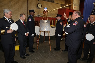 FDNY Chaplain Monsignor John Delendick blesses the centennial plaque at Ladder 134