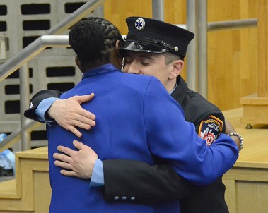 Survivor Madonna Gay hugs one of her rescuers, FDNY Paramedic Brendan Ryan.