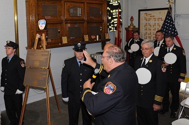 FDNY Chaplain Monsignor John Delendick blesses the plaques marking Engine 279 and Ladder 131's centennial.