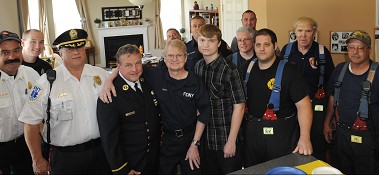 FDNY Paramedic John Wyatt (center with glasses), stands between his former coworker Deputy Chief from the Bureau of Health Services Jay Swithers (center left), his son Peter, 17, (center right), New York City firefighters and Vineland emergency responders.