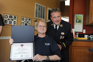 Retired FDNY Paramedic John Wyatt and EMS Deputy Chief Jay Swithers with the 25-year award.