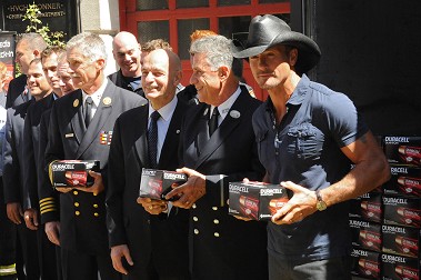 FDNY members, including Fire Commissioner Salvatore Cassano, Chief of Department Edward Kilduff, Chief of Training Thomas Galvin and Director of Fire Safety Education Anthony Mancuso are joined by musician and actor Tim McGraw.