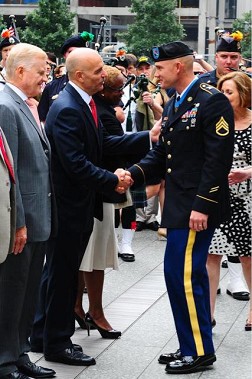 Fire Commissioner Salvatore Cassano meets Army Staff Sergeant Ty Carter, recipient of the Medal of Honor, at the 9/11 Memorial.