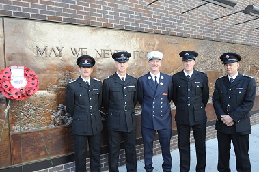The North Yorkshire Firefighters with FDNY Lt. Jack Kielty, who helped them along their journey, lay a wreath at the 9/11 Memorial Wall outside Engine 10/Ladder 10.