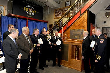 A plaque is blessed to honor the Engine 280/Ladder 132's centennial.