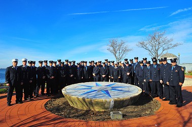 The members of Engine 268/Ladder 137 in front of a 9/11 memorial mosaic they created in a park near the firehouse.